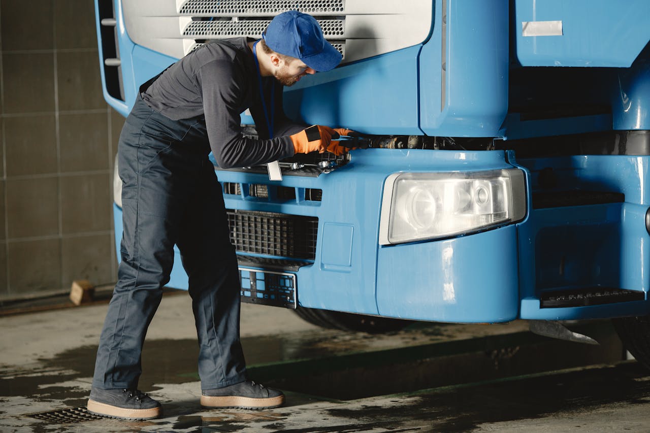 A mechanic inspects a truck
